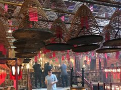 05B Bell shaped joss stick coils of incense above gold urns Man Mo Temple Hong Kong